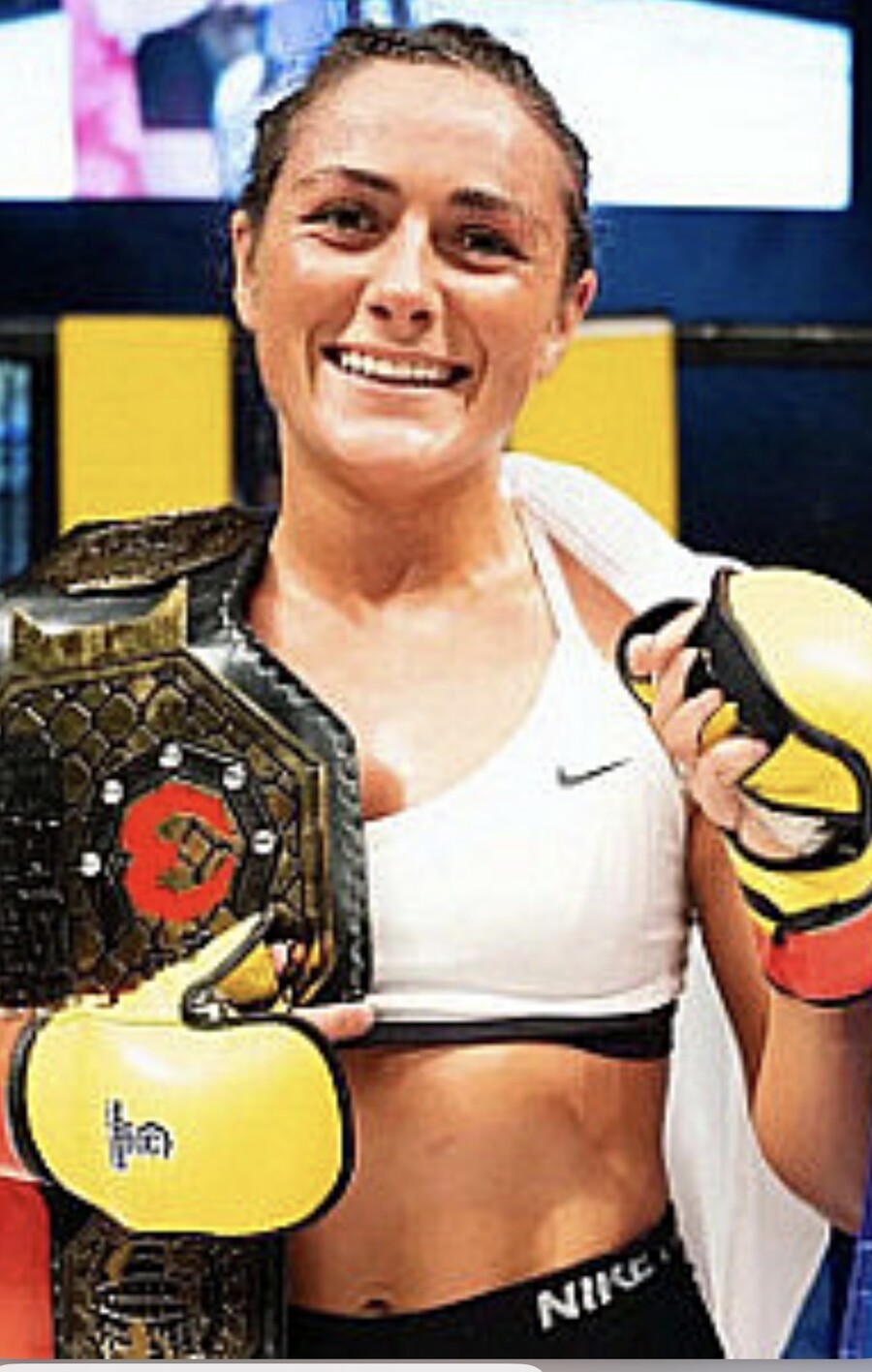 Delphine Benouaich with championship belt — gym